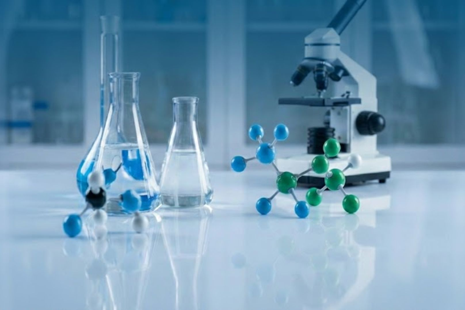 Modern scientific laboratory banner featuring glass beakers, a microscope, and a molecular structure model representing CBD research and development.